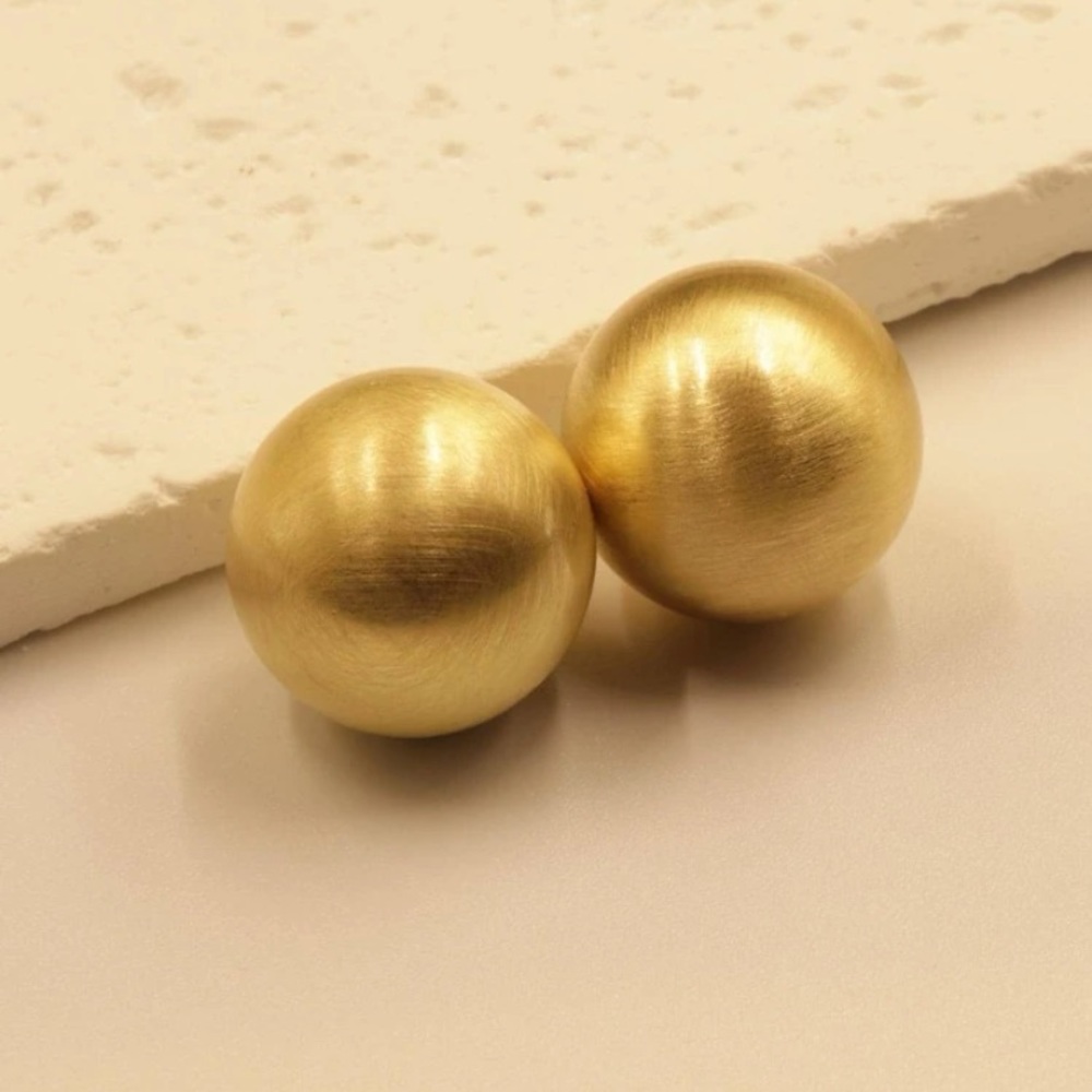 Golden ball earring.